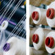 Большие бобины цветных ниток стоят на ткацком станке на современном промышленном предприятии «Белпа–мед» по производству медицинских бинтов, бандажей и корсетов в городе Молодечно